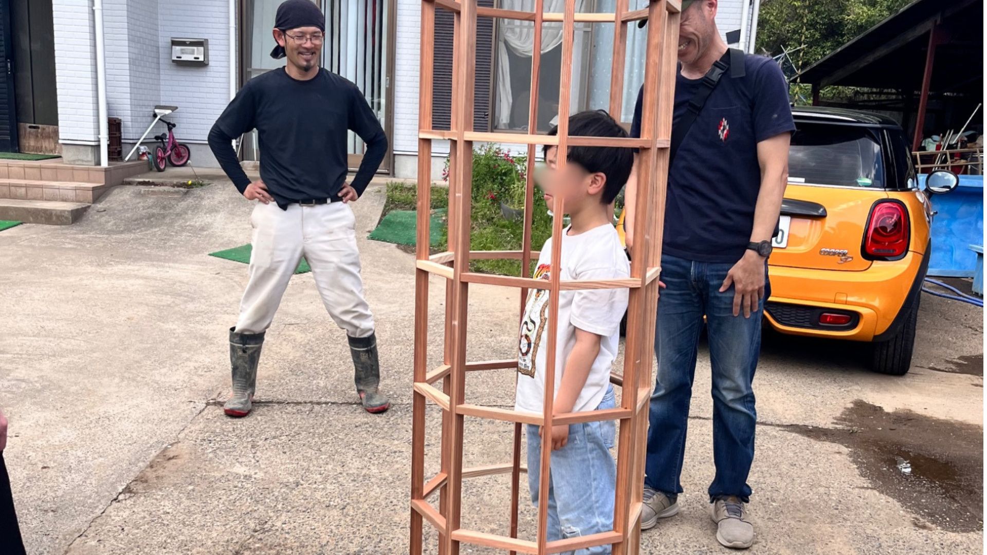 田植えの目印をつける道具の中に入る子ども